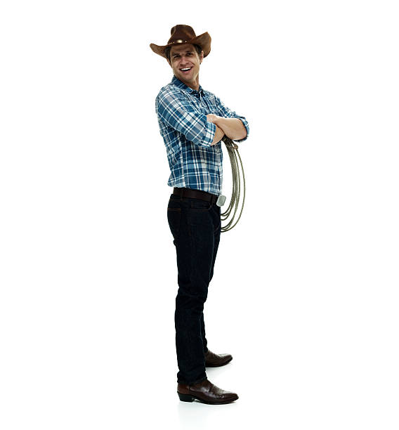 istock Smiling cowboy standing with arms crossed 506507094