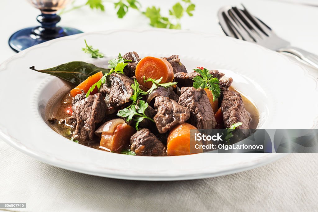 Beef stew with carrot on white. Selective focus. Beef Bourguignon Stock Photo