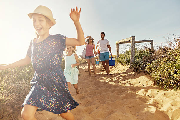 She's super excited... Shot of a young family arriving at the beachimage806237.jpg weekend trip stock pictures, royalty-free photos & images