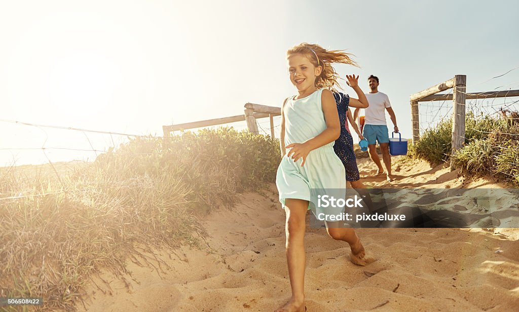 She loves the beach Shot of a young family arriving at the beachimage806237.jpg Beach Stock Photo