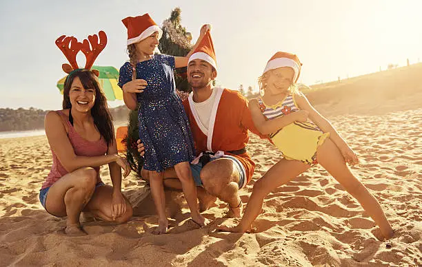 Shot of a young family spending Christmas at the beachimage806237.jpg