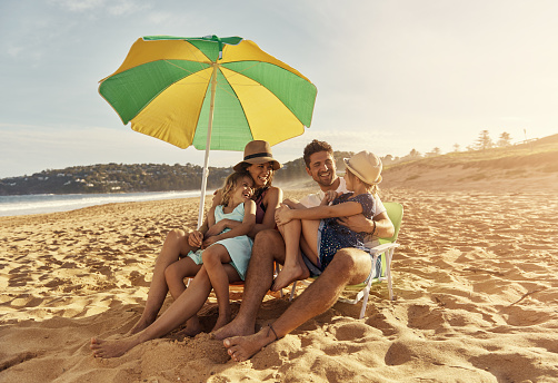 Shot of a young family sitting on the beachimage806237.jpg