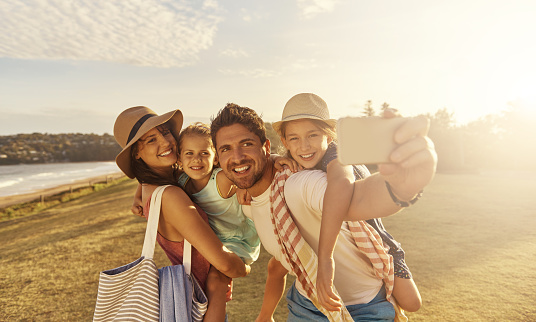 Shot of a father taking a selfie with his family while out on the beachimage806237.jpg