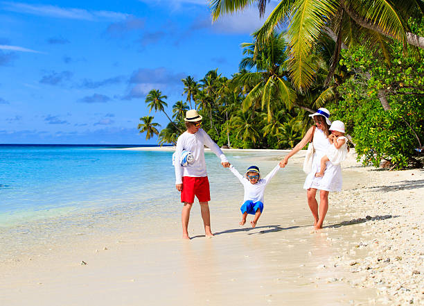 istock family with two kids playing on beach 506512368