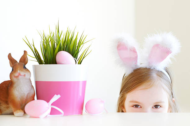istock Adorable little girl wearing bunny ears on Easter 506512996