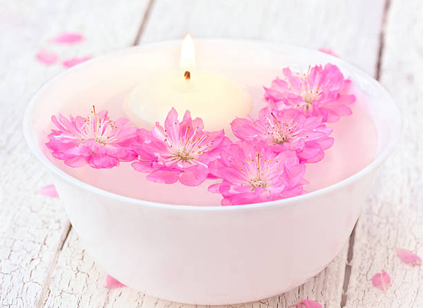 istock Sakura flowers and candle in a white bowl 506514192