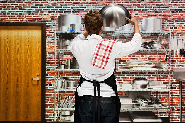istock Rear view of chef working in kitchen 506514638