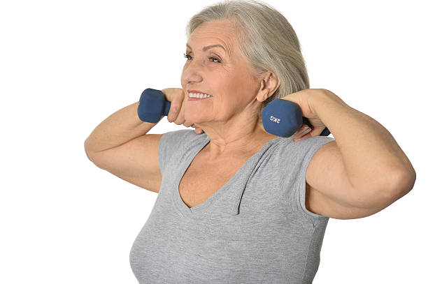 istock Senior woman exercising with dumbbells 506514664