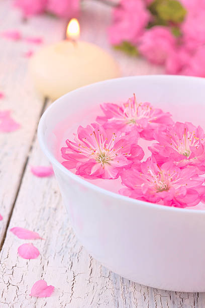 istock Sakura flowers and candle in a white bowl 506518060