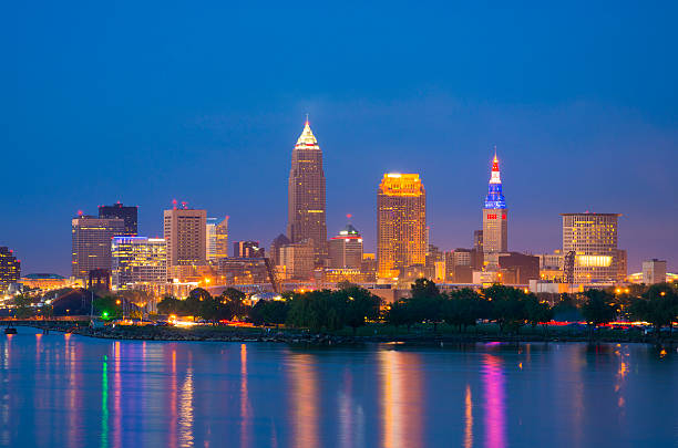 Cleveland skyline and Lake Erie at dusk Cleveland downtown skyline at dusk with Lake Erie in the foreground. terminal tower stock pictures, royalty-free photos & images