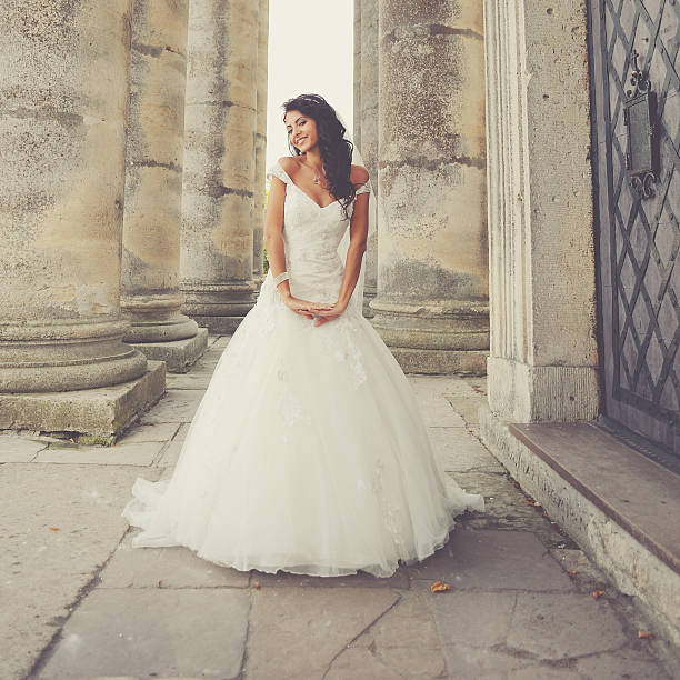 Beautiful bride posing on the steps of an old church