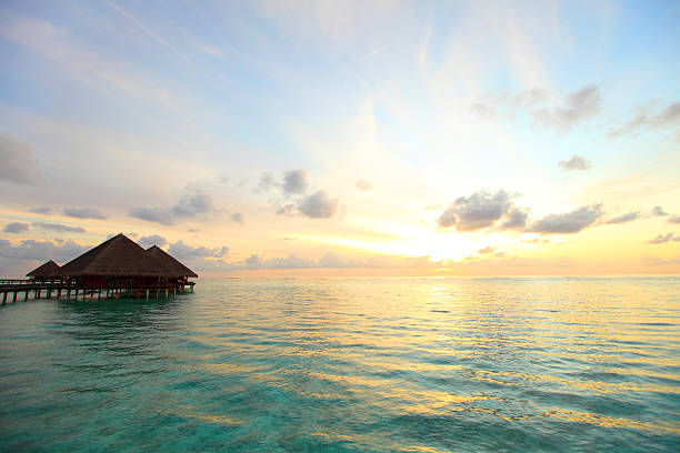 istock maldivian houses on sunrise 506541215
