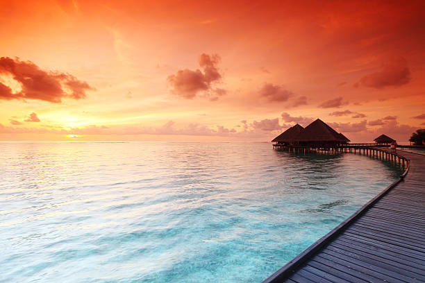 istock maldivian houses on sunrise 506541219