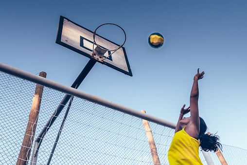 brazilian sportswoman throwing basketball to hoop