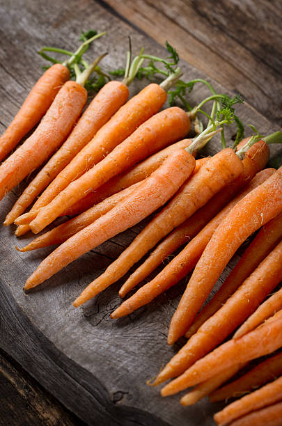 istock Orange carrots on a wooden board 506544236