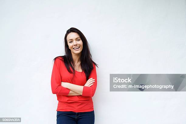 Smiling Young Woman In Red Shirt Smiling Against White Background Stock Photo - Download Image Now