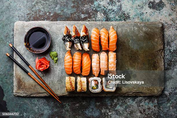 Sushi Rolls Set On Stone Slate Stock Photo - Download Image Now - Sushi, Food, Chopsticks