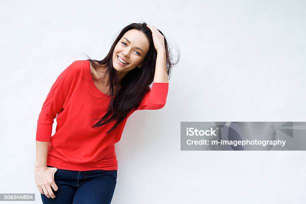Smiling Young Woman With Hand In Hair Stock Photo - Download Image Now - Hand In Hair, One Woman Only, Women