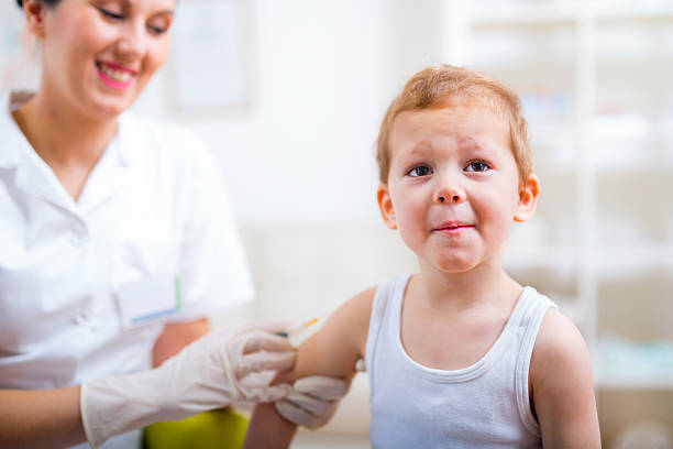 istock Pediatrician makes vaccination to small boy 506545376