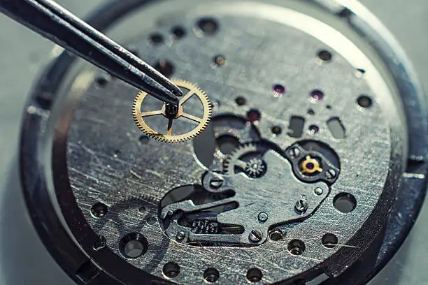 tweezers and disassembled mechanical watches