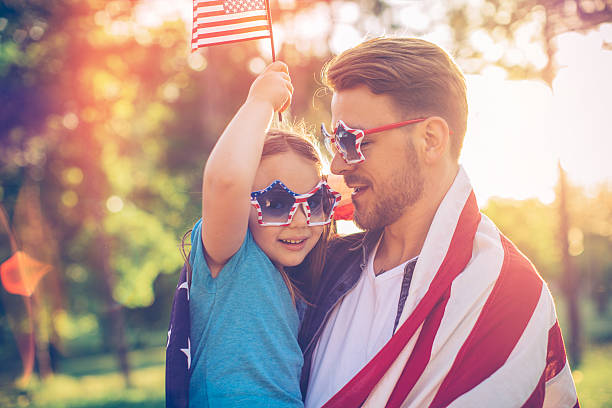 istock Father and daughter outdoors in a meadow on july 4th. 506545906