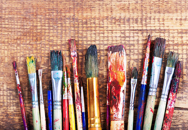 istock colorful paint brushes on a wooden table 506546000