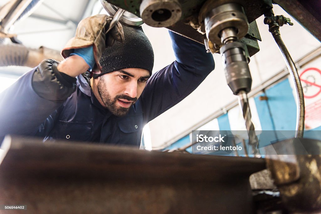 Worker at milling machine in workshop. Metal Worker Stock Photo