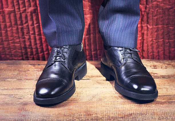 istock man's feet in a black shoes 506546752