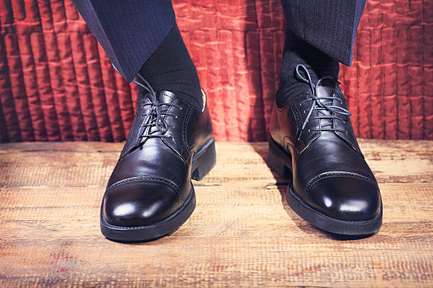 istock man's feet in a black shoes 506546872