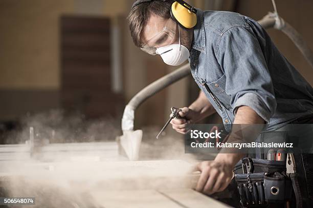 Professionally Dressed Carpenter Varnishing Board Stock Photo - Download Image Now - Dust, Occupation, Working