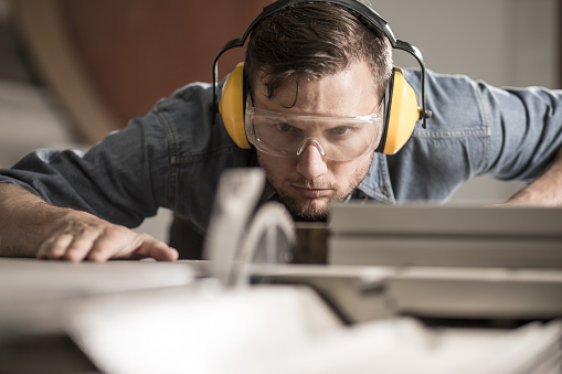 Horizontal photo of professional saw operator preparing ideal board