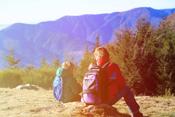 istock father and son hiking in scenic mountains 506549912