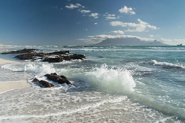 Cape Town-view to theTable mountain from Bloubergstrand Beach -the ocean with big waves