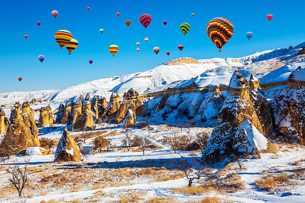 Cappadocia of winter in Turkey, with balloon Cappadocia under  the snow cappadocia winter photos stock pictures, royalty-free photos & images