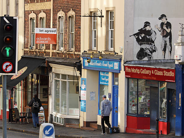 Police sniper as depicted by the street artist Banksy, Bristol Bristol, England - February 26, 2011: Police sniper as depicted by the artist Banksy on a building in Upper Maudlin Street banksy stock pictures, royalty-free photos & images