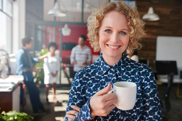 istock Happy young businesswoman having coffee 506552884