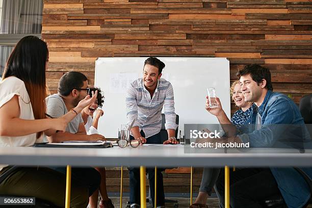 Happy Young People Having A Business Meeting Stock Photo - Download Image Now - Travel Agency, Marketing, Teamwork