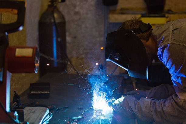 istock Professional metalworker welding something in metal shop 506554072