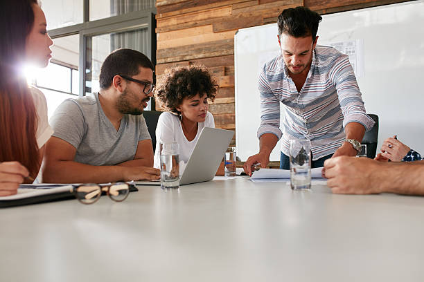 istock Leader showing business plan to colleagues during a meeting 506554122