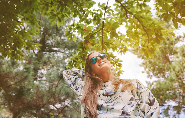 istock Woman with sunglasses touching over nature background 506557262