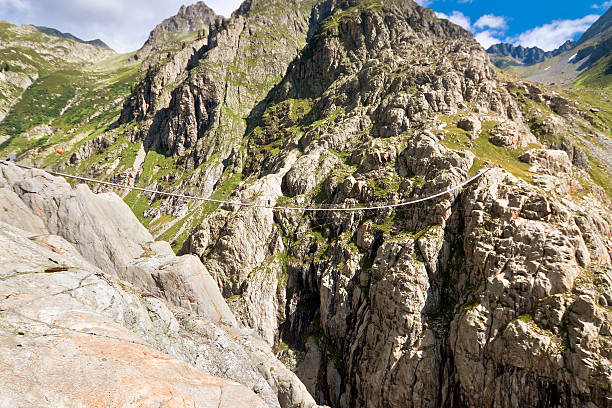 istock Trift Bridge, pedestrian-only suspension bridge in Alps. Svitzerland 506557638
