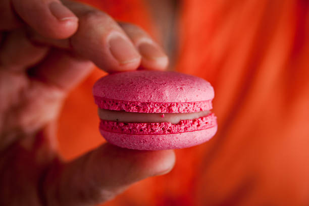 istock Woman holds in her hand macaroon 506558418
