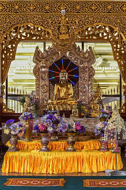istock Buddha surrounded by dark halo with eight rainbow LED lights 506558676