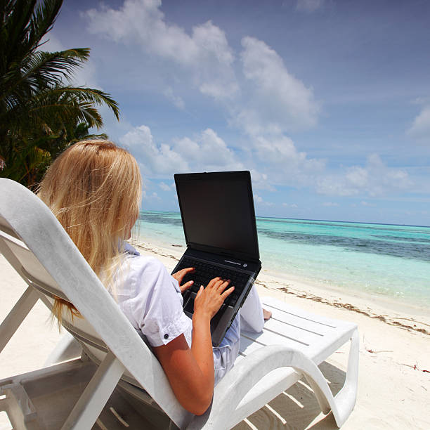 istock tropical business woman with laptop 506571103