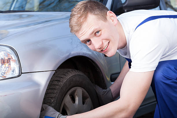 istock Auto mechanic checks a car tire 506571551