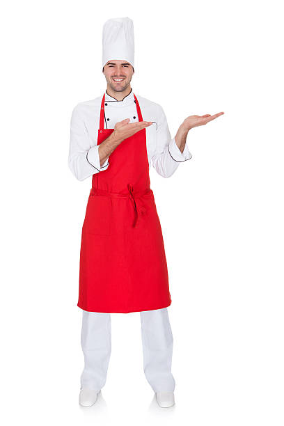 istock Portrait of cheerful chef in uniform presenting 506572505