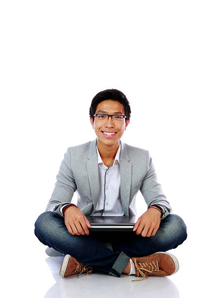 istock man sitting on the floor with laptop 506575285