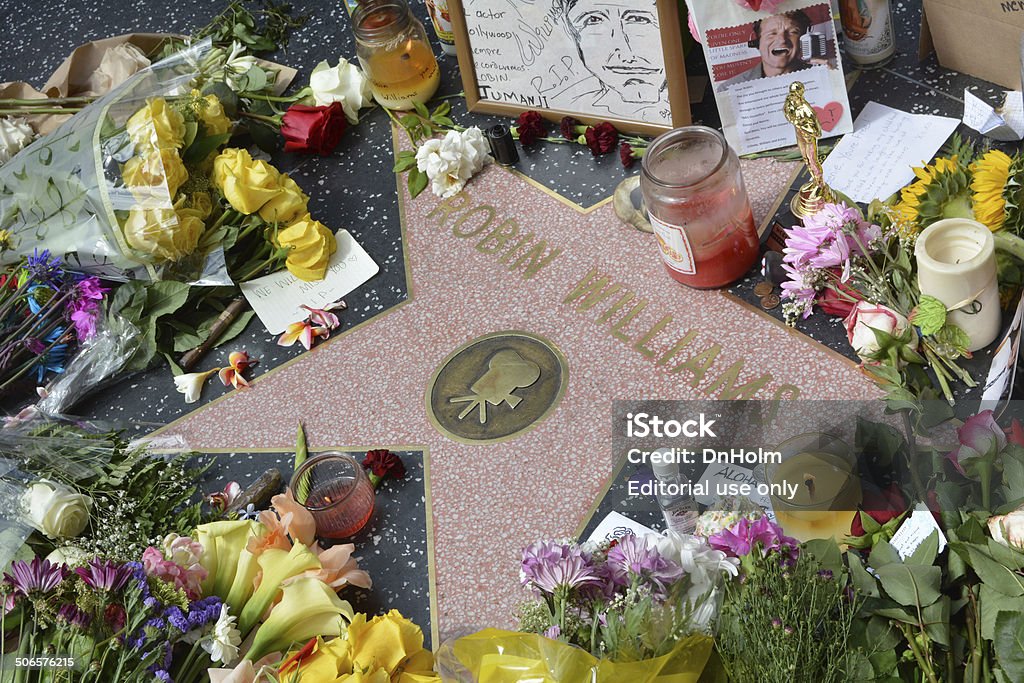 Robin Williams Memorial Hollywood, CA, USA – August 12, 2014: Robin Williams' star on the Hollywood Walk of Fame is surrounded by flowers and various memorial tributes left by fans on August 12, 2014. Actor Stock Photo