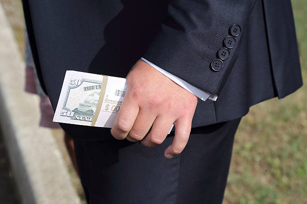 istock man in a nice suit holding in his hand banknotes 506582694
