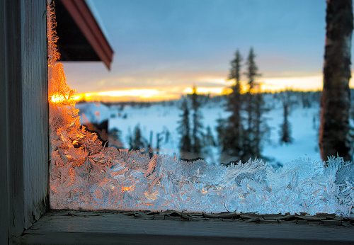 Frost-work on an run down window of a mountain cabin in Norway